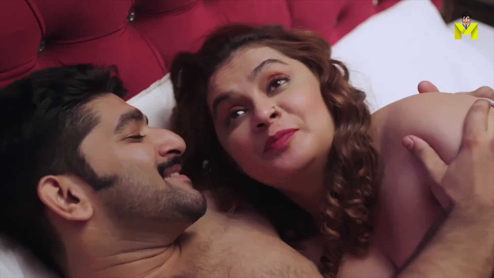 Spicy Bollywood scene with romantic actors lying on bed for 2022 700MB movies download.