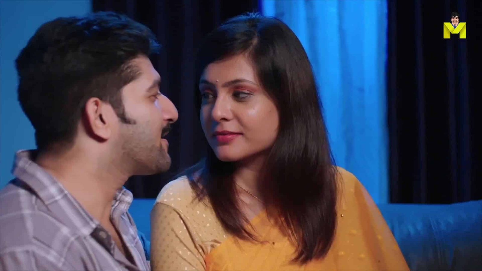 Romantic couple scene from Indian movie, love and intimacy portrayed in a cozy setting.