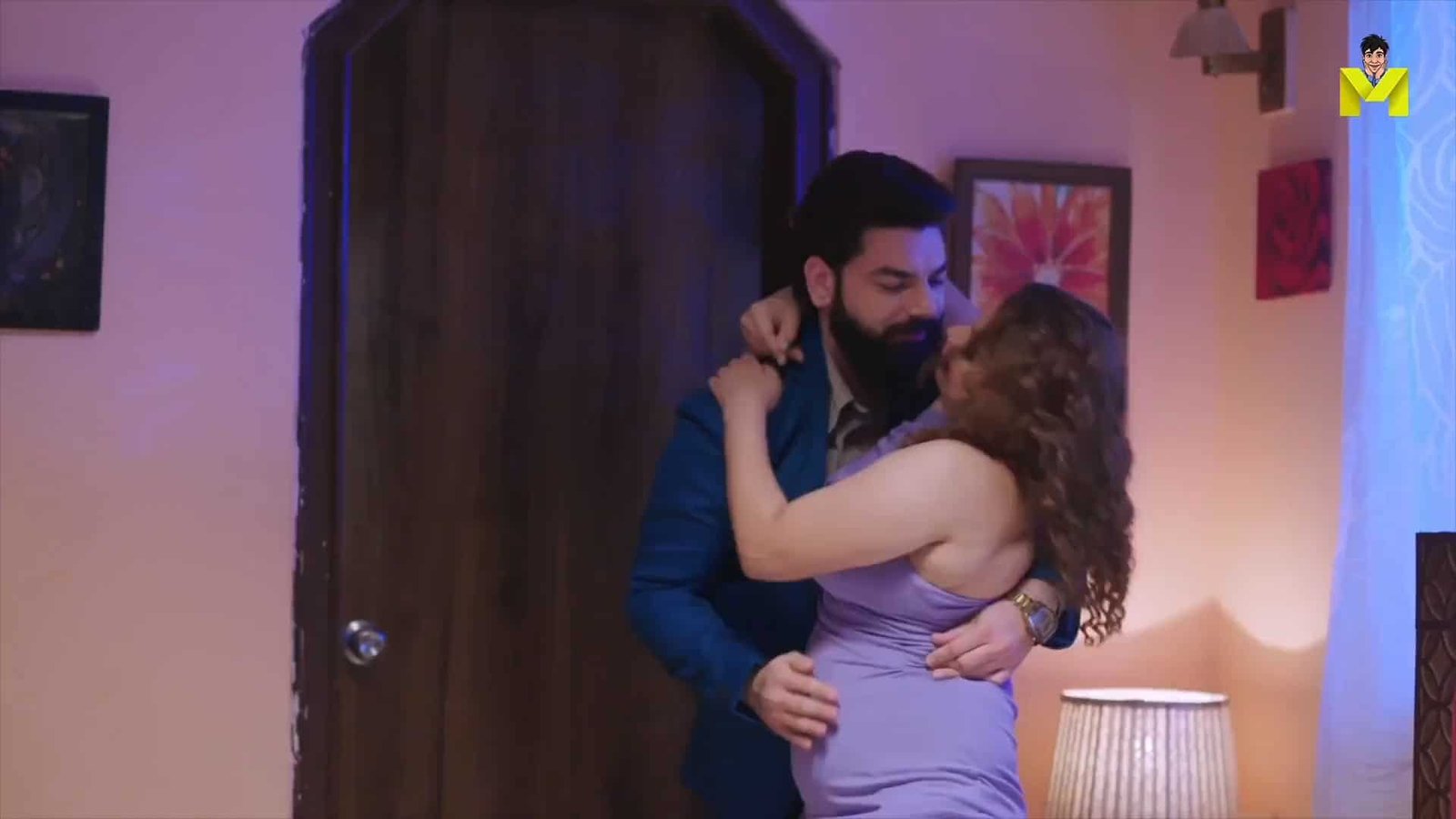 Intimate couple dancing passionately in a cozy room with soft lighting and colorful wall art, romantic scene from 1Filmy4wap 2022.