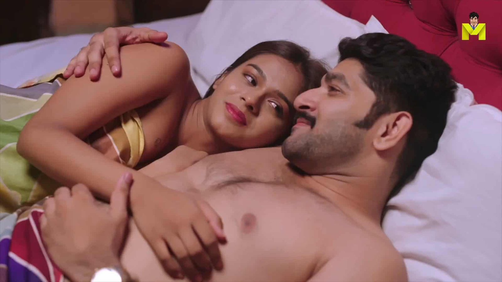 Romantic couple lying in bed, enjoying intimate moment together.